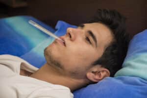 sick man with thermometer