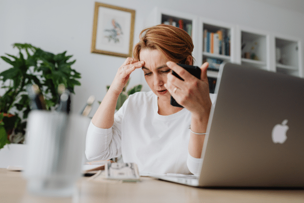 Stressed woman at desk — high cortisol can make weight loss over 40 harder
