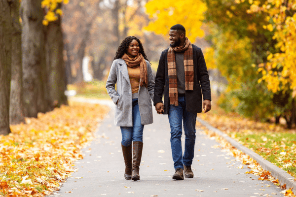 Couple walking outdoors in autumn, symbolizing balance, freedom, and confidence while transitioning off GLP-1 medication.